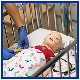 Students with an infant manikin